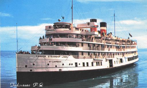 Passengers lean against the railings of a white ship with two red, white and black smokestacks.