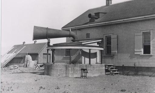 Two funnel-shaped devices, one large and one small, affixed to the roof on two parts of a building.